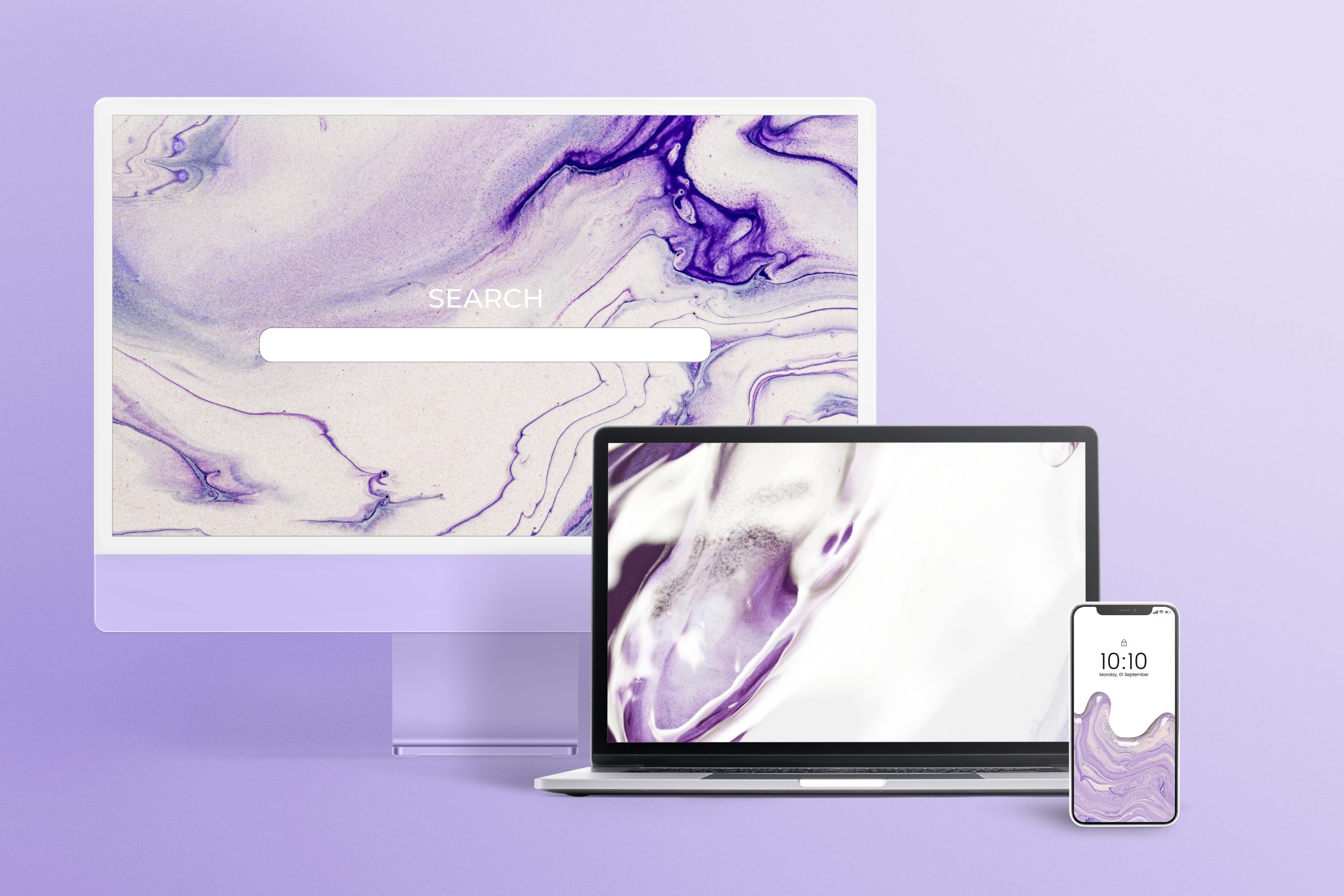 A computer, laptop, and a smartphone on a light purple background